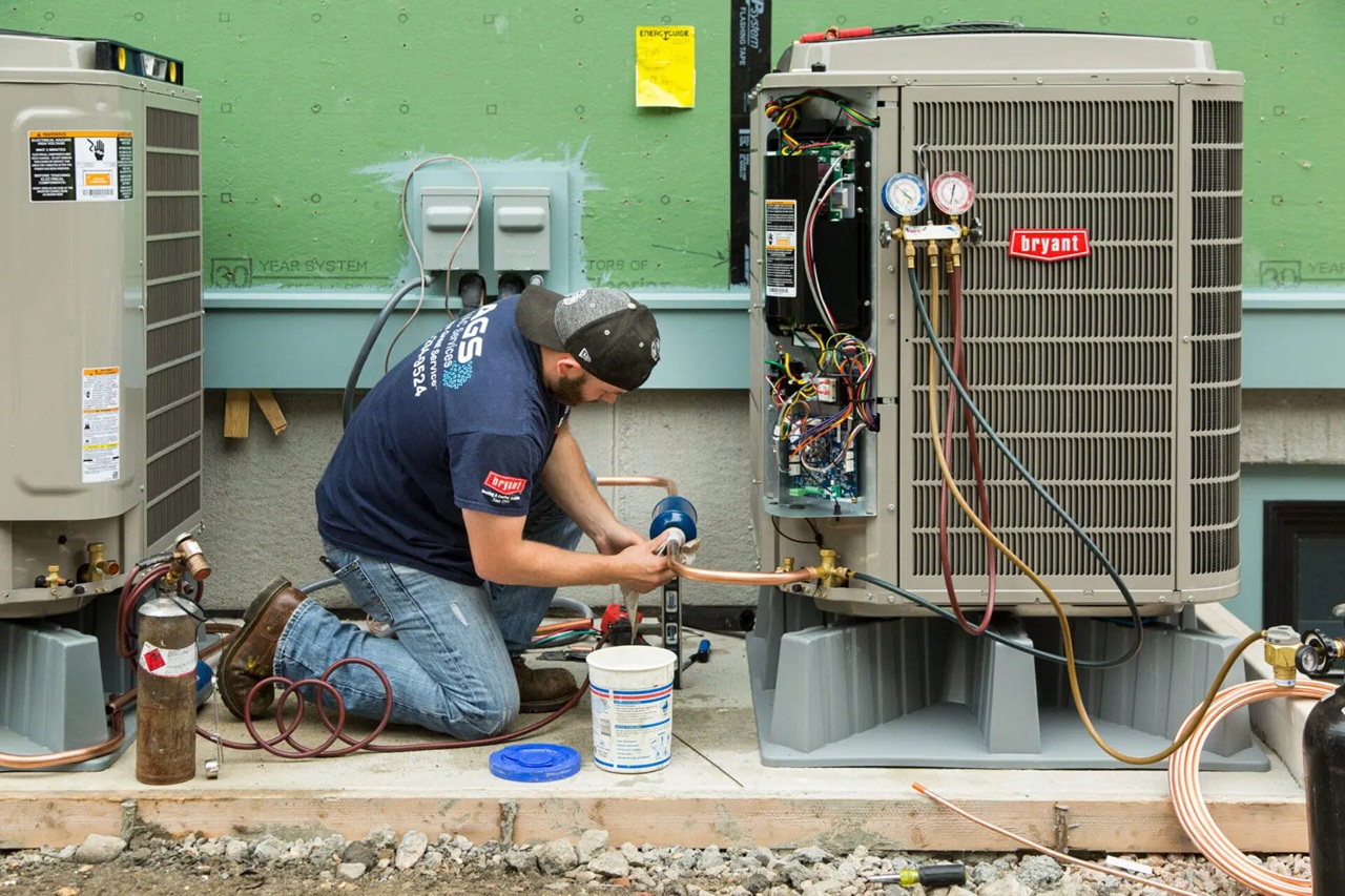 HVAC technician checking system gauges during maintenance