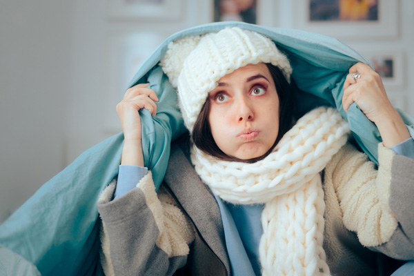 Person bundled up freezing cold in harsh snowy winter